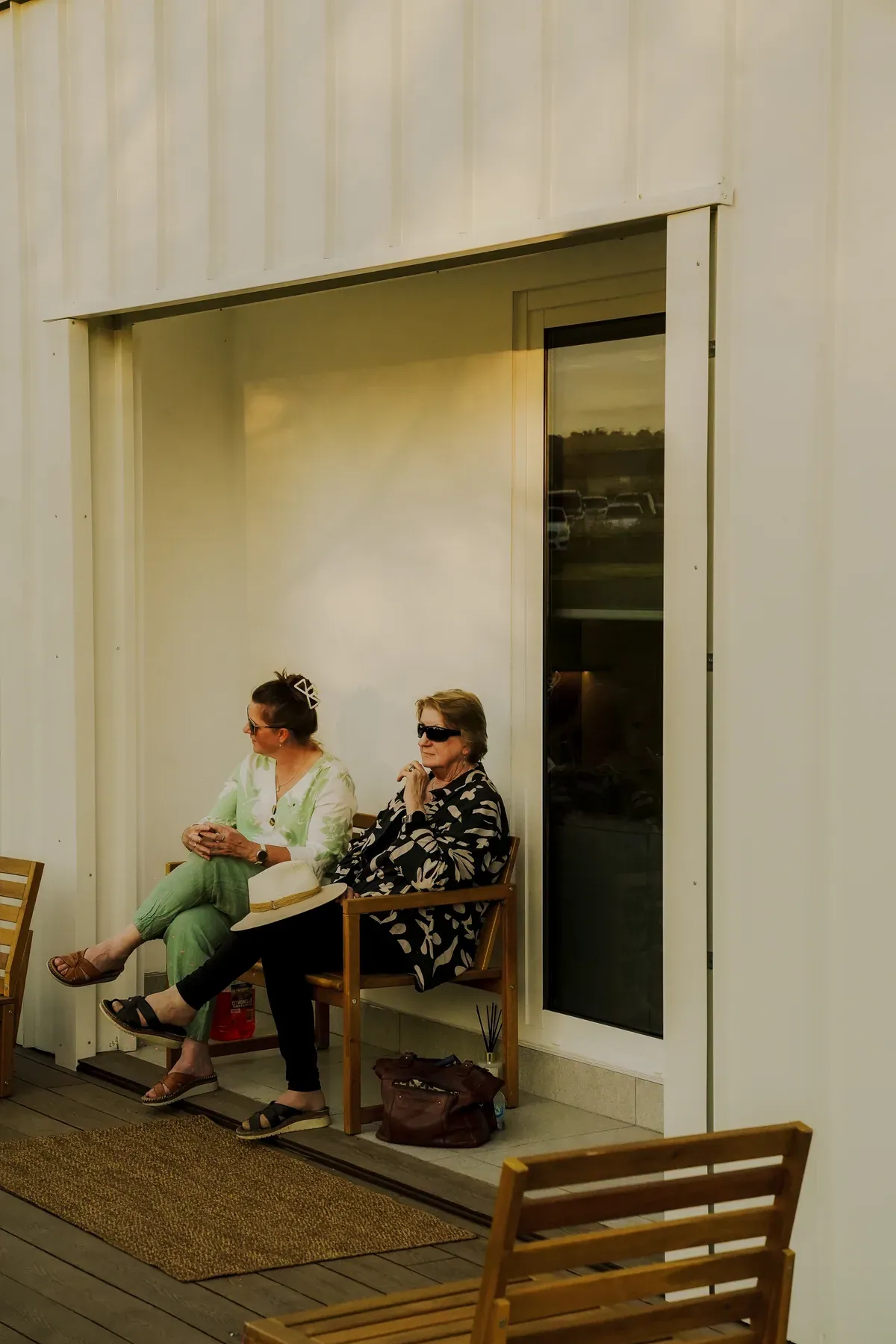 Visitors sitting outside beside the Bonsai display home.