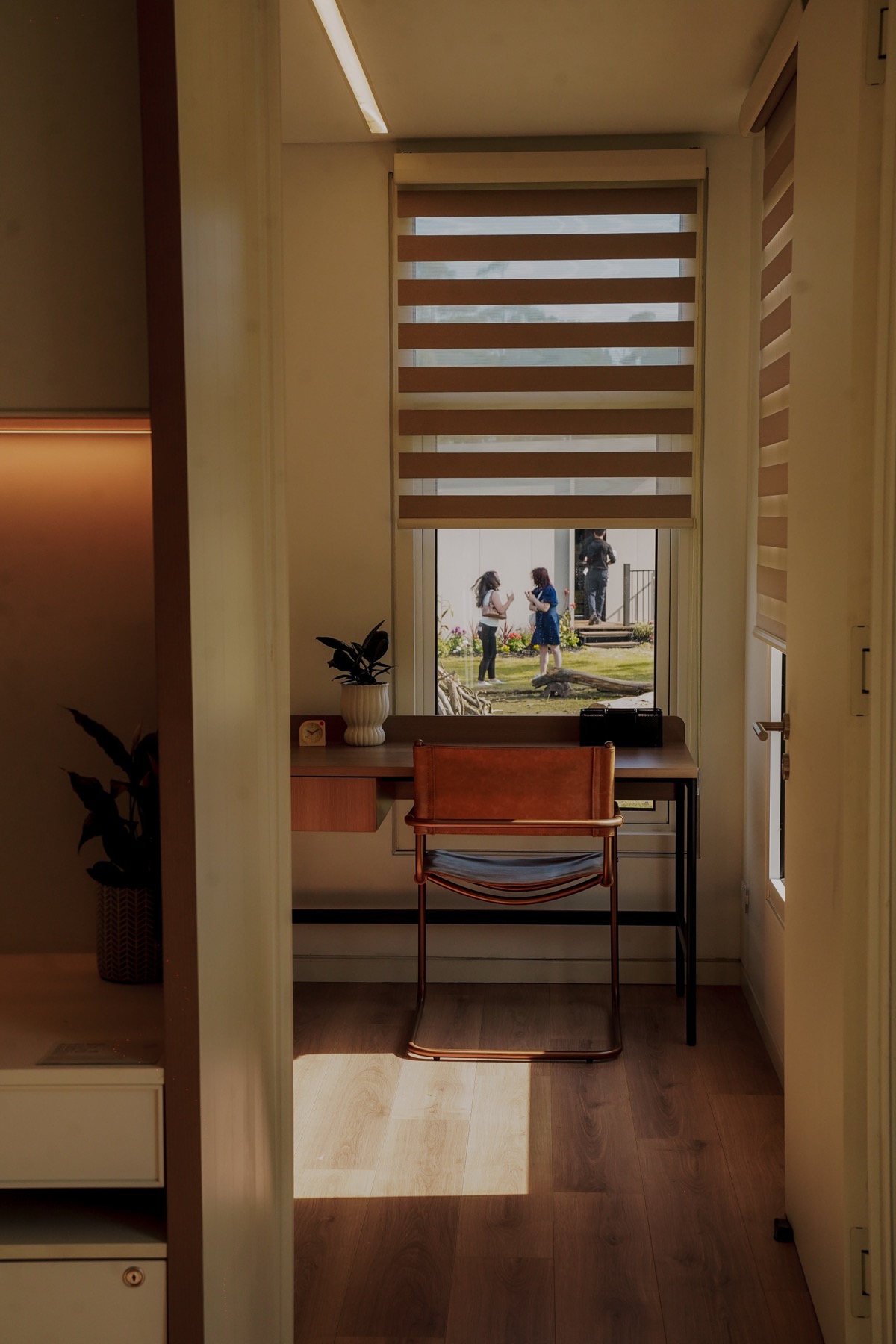 A family at the door of a Bonsai home, photographed on site