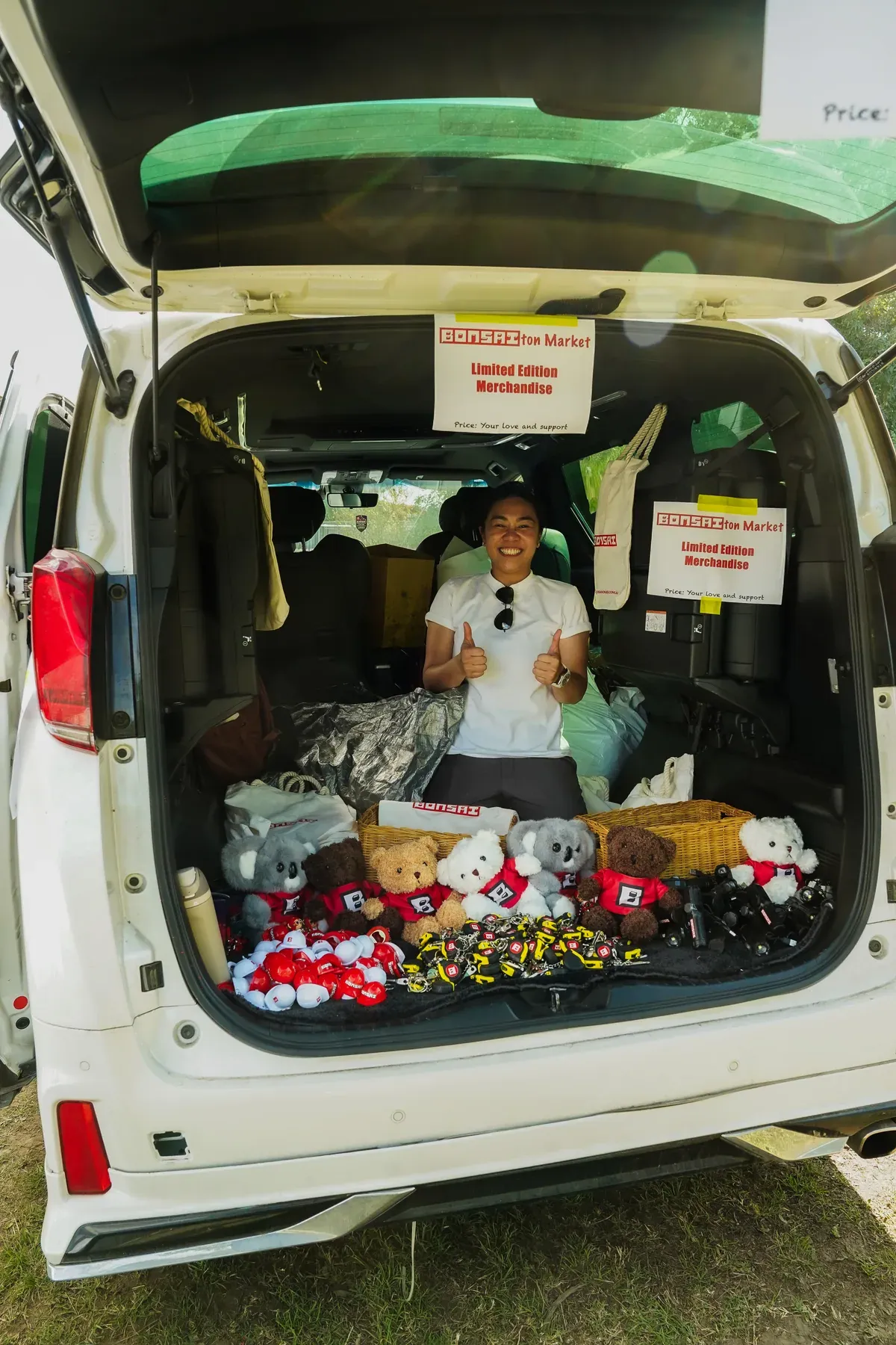 The Bonsai launch day merch market set up from a vehicle.