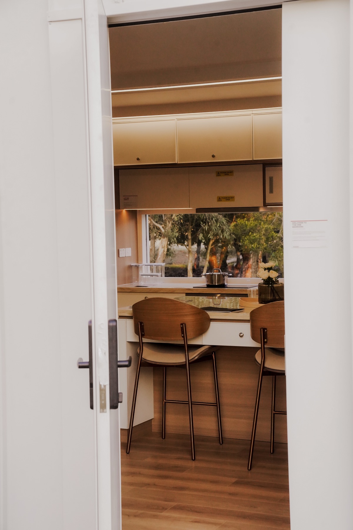 Looking through the open front door into the Bonsai one-bedroom kitchen.