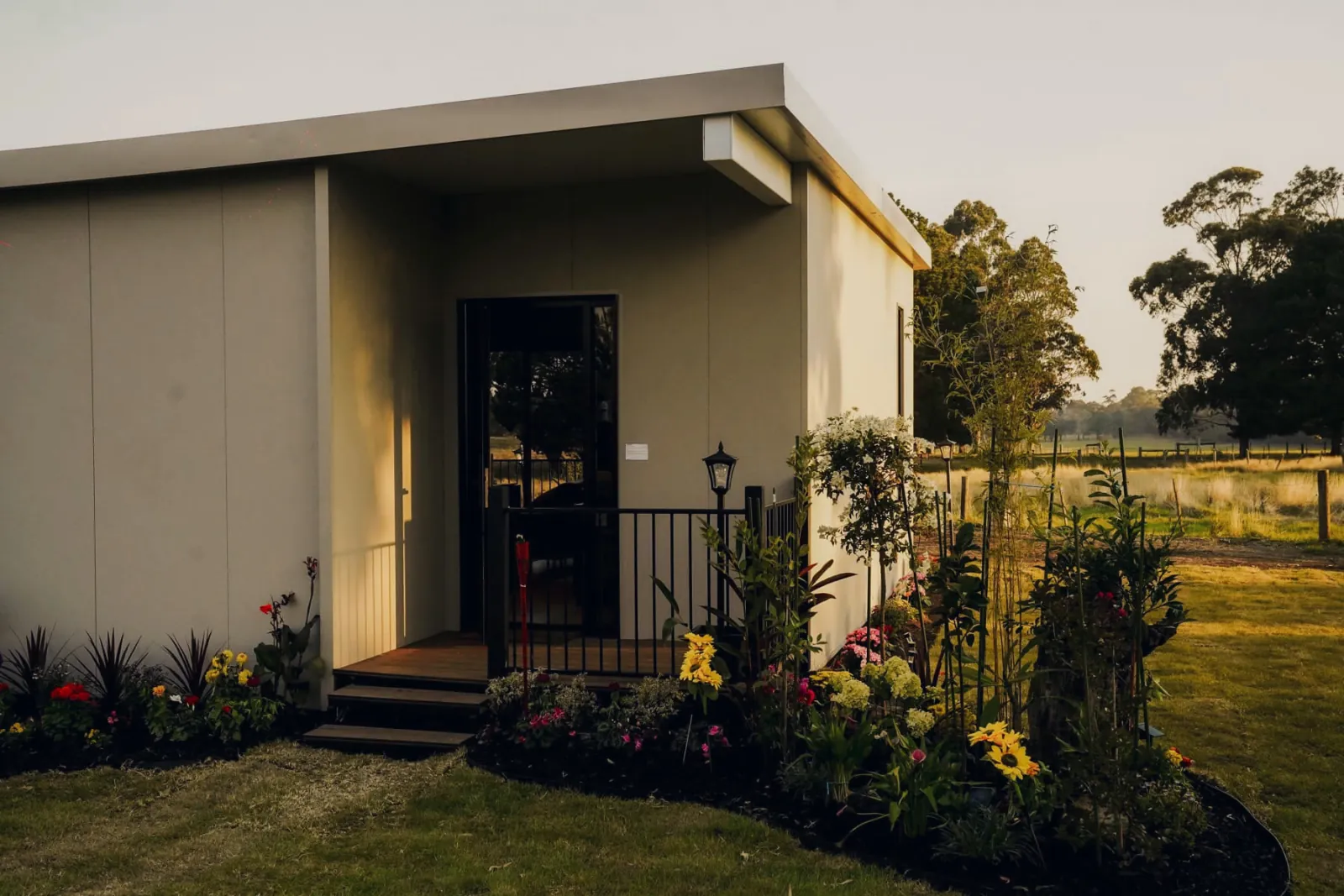 The outside of a Bonsai display home, its deck and garden