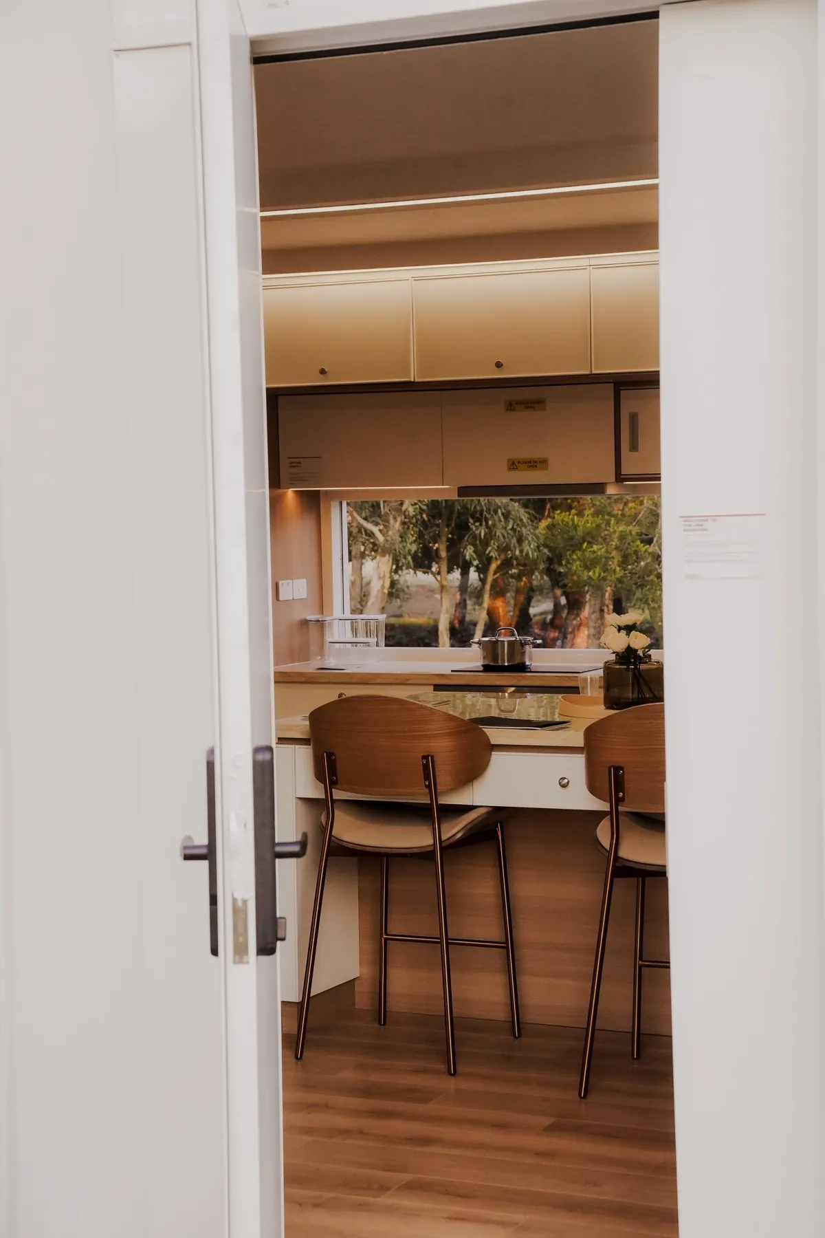 Through the open front door of the One Bedroom display home into the kitchen