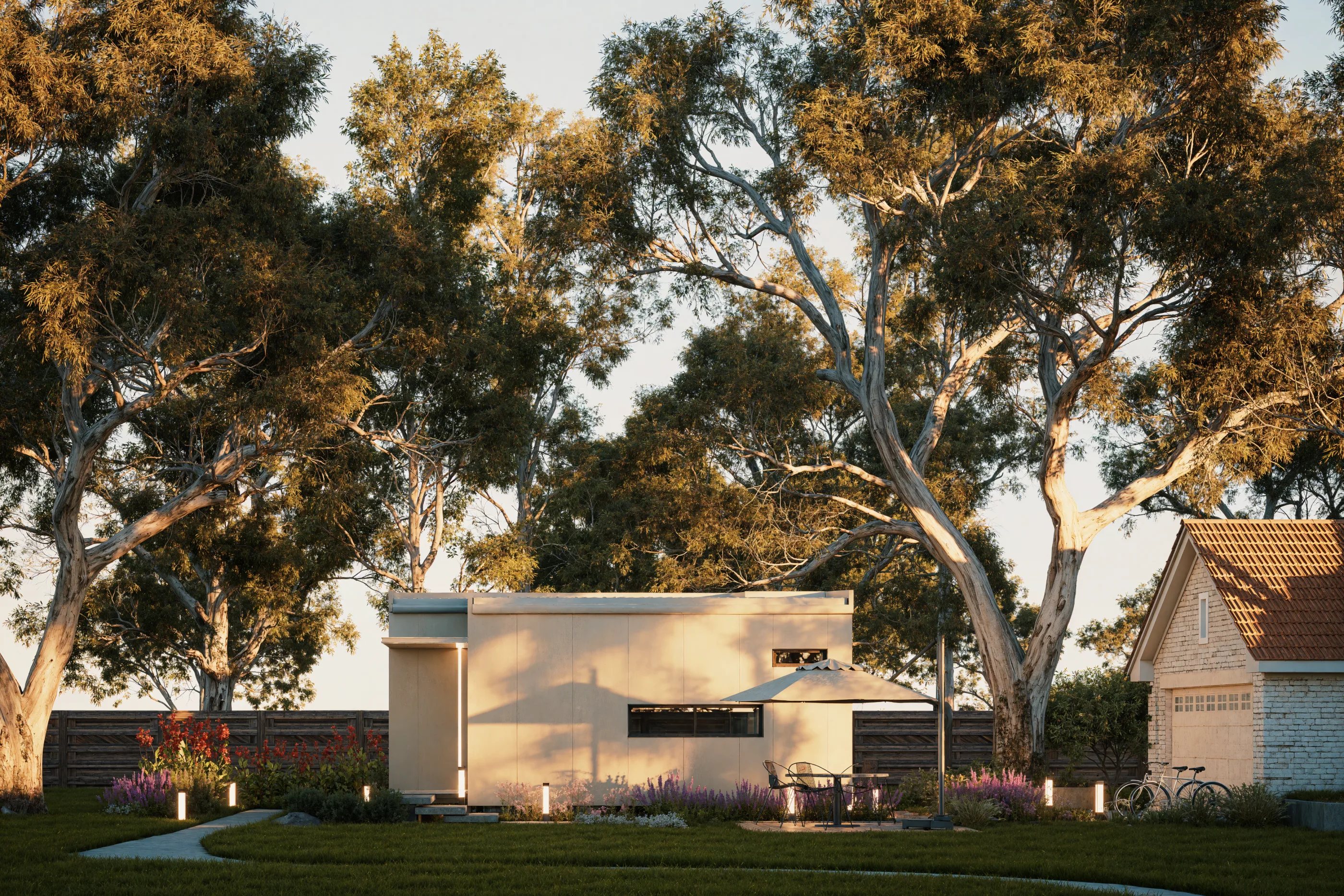 The Studio at the end of a garden path, under gum trees in late afternoon light